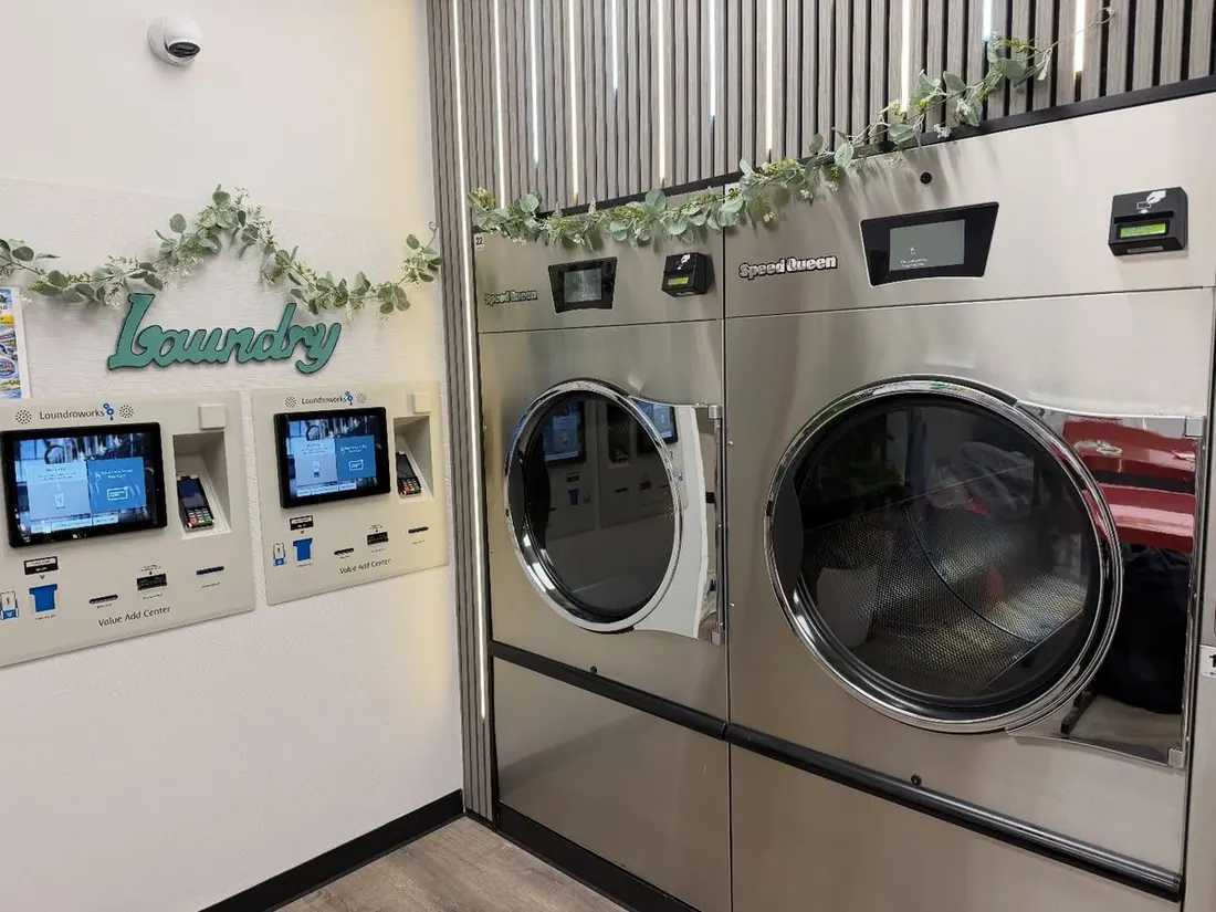 Laundroworks Value Add Center card kiosks beside the Laundry sign
