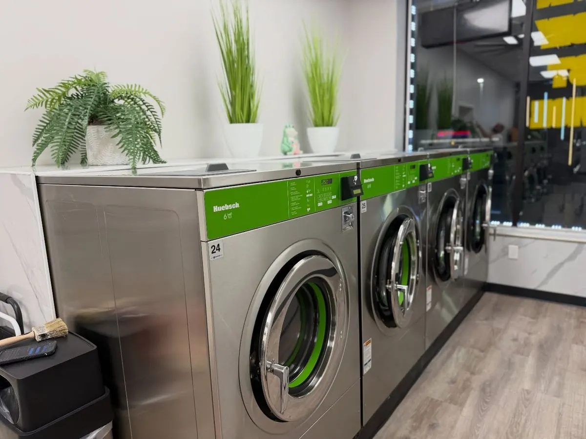 Brand-new green Huebsch high-efficiency washers in a row