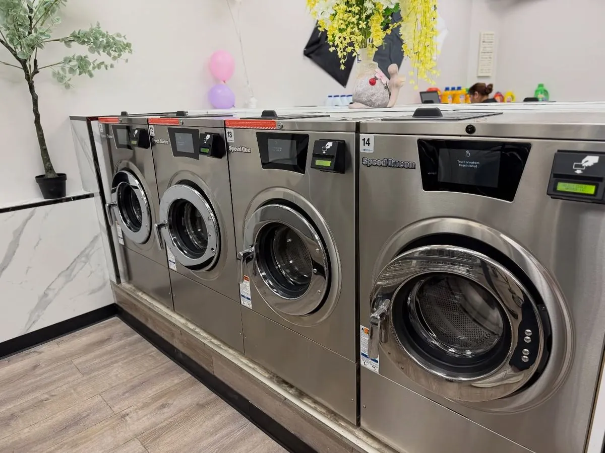 Newburgh Express Laundry staff folding wash & fold laundry at the marble counter